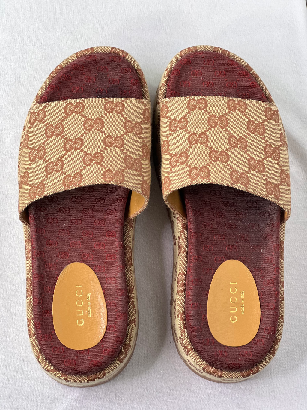 Top view of Gucci GG platform sliders showing wide canvas strap and burgundy cushioned footbed.