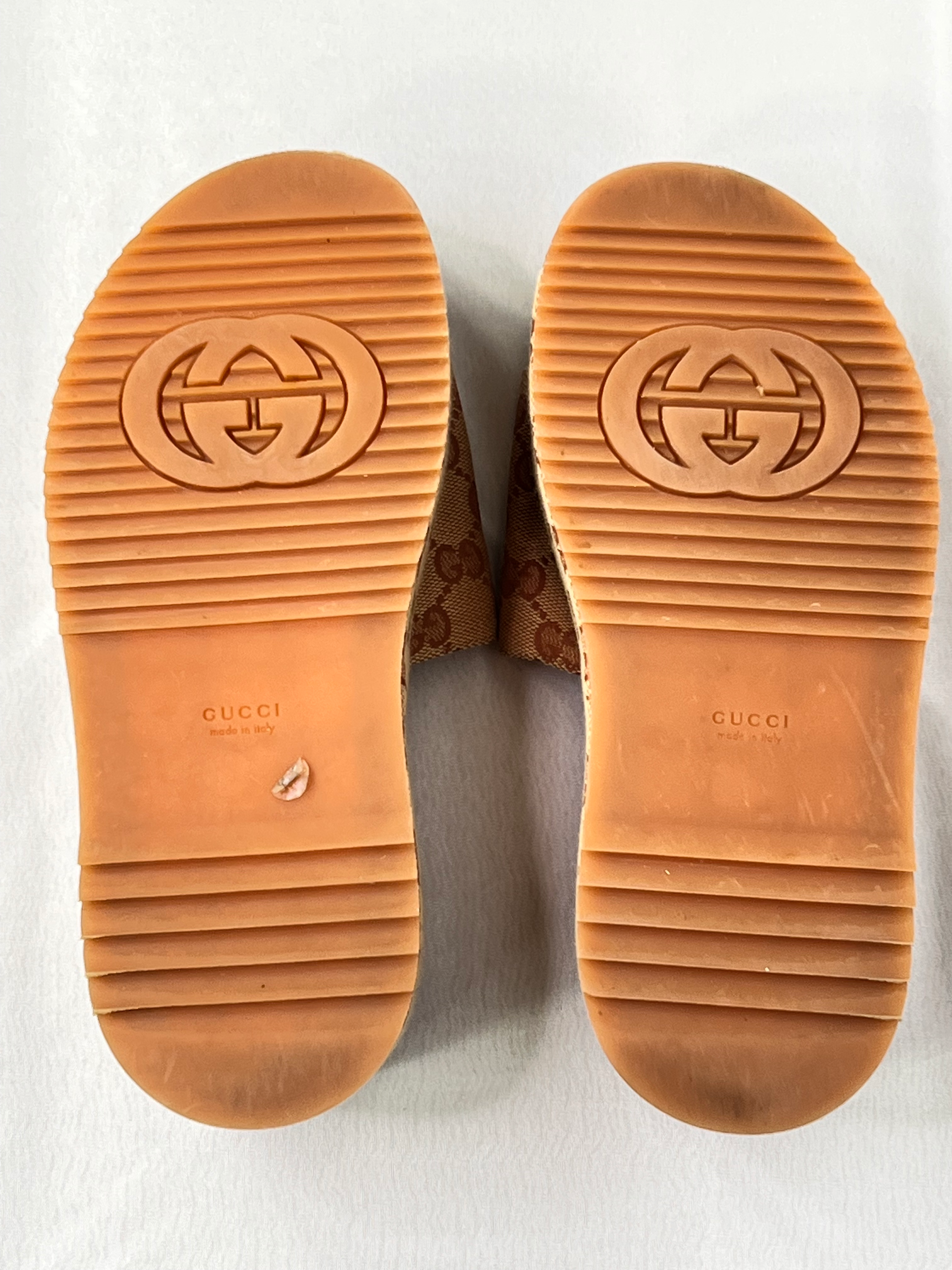 Underside view of rubber sole with Gucci logo and tread on pre-owned platform sliders.
