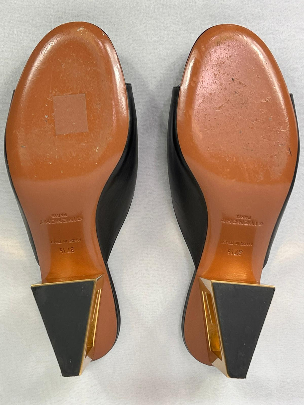 Pre-owned Givenchy heeled mules displaying leather soles with light wear, underside view.