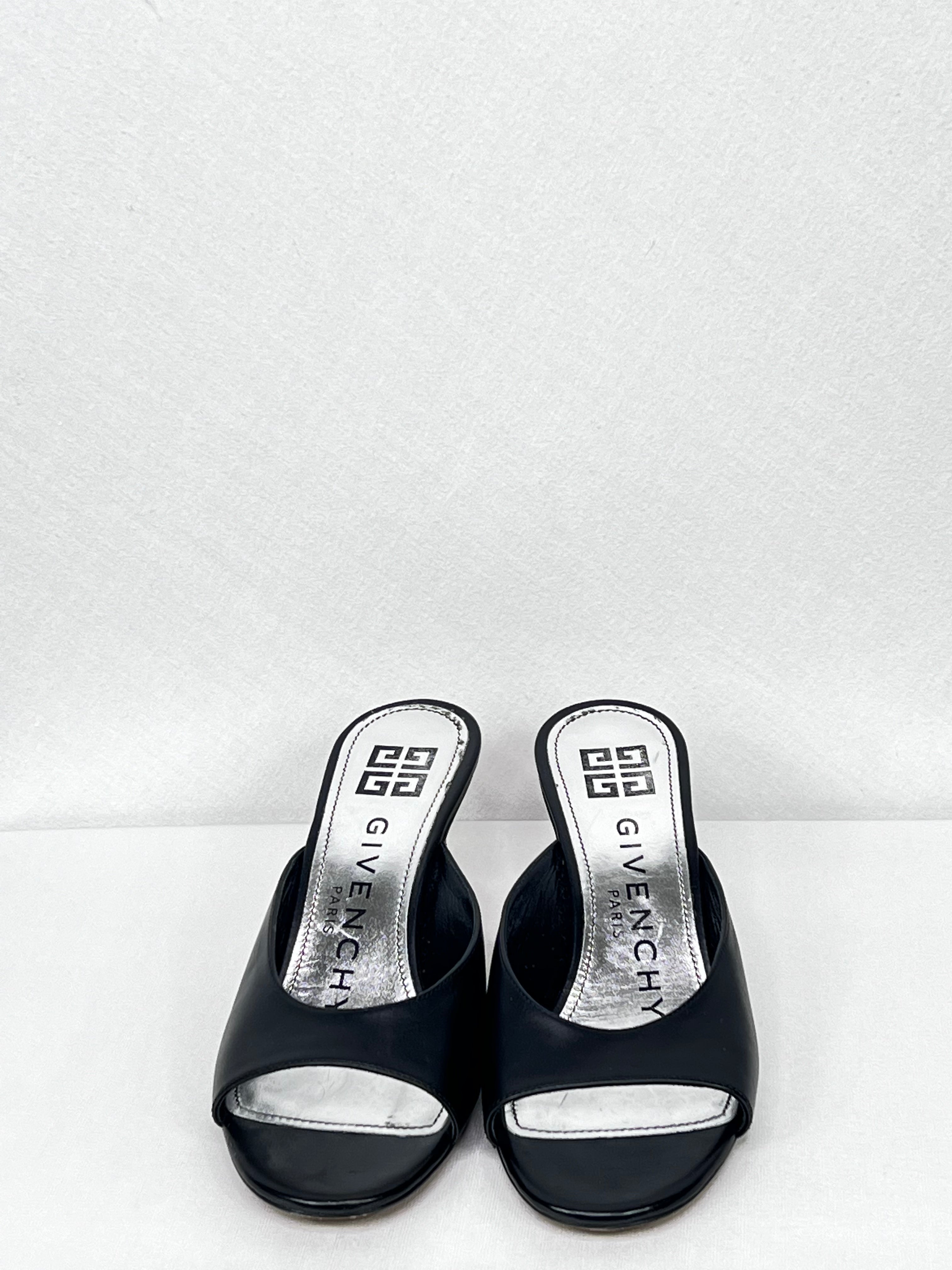 Pre-owned Givenchy leather mules showing open-toe design and branded insole, front view.