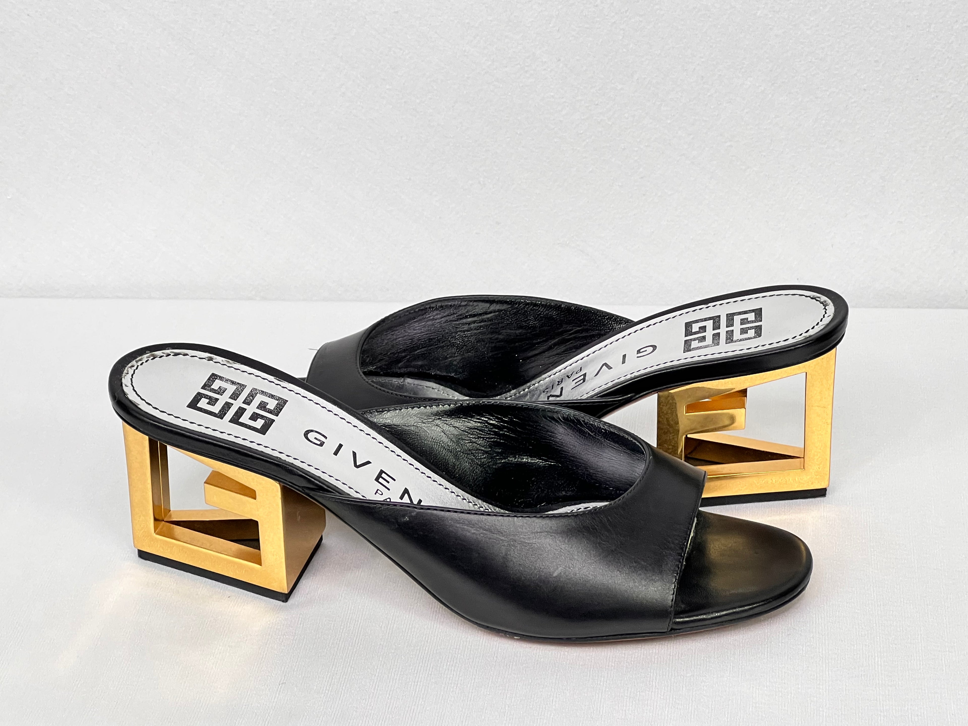 Pre-owned black leather Givenchy mule sandals with gold-tone geometric block heel, side view