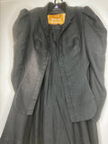 Front view of Vivienne Westwood vintage black cropped jacket and matching culotte set on hanger, showing structured tailoring and gold label lining.