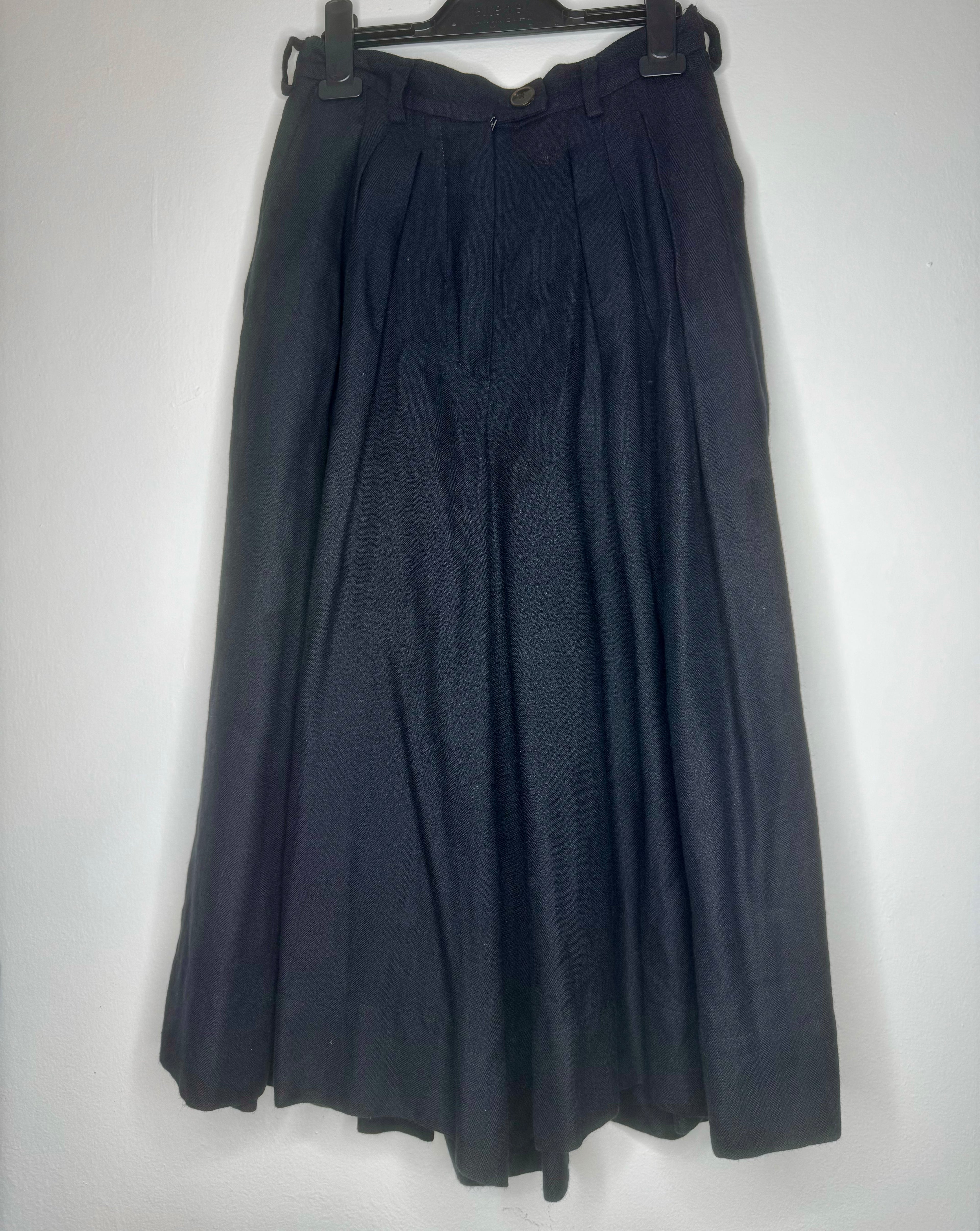 Front view of vintage Vivienne Westwood black culotte skirt featuring high waist, soft pleating and wide-leg silhouette.