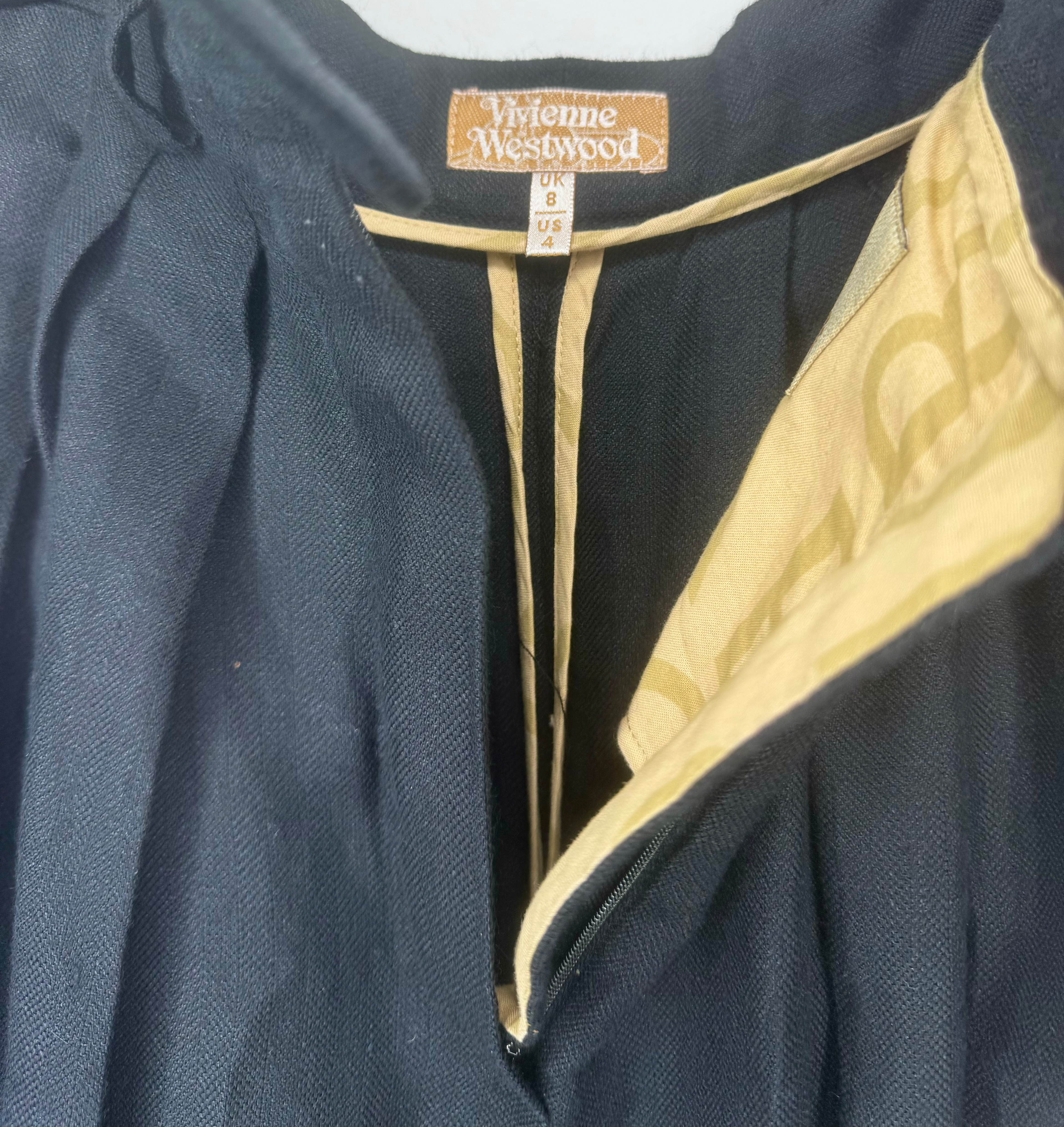 Close-up of waist and pleat detailing on a vintage Vivienne Westwood black culotte skirt.