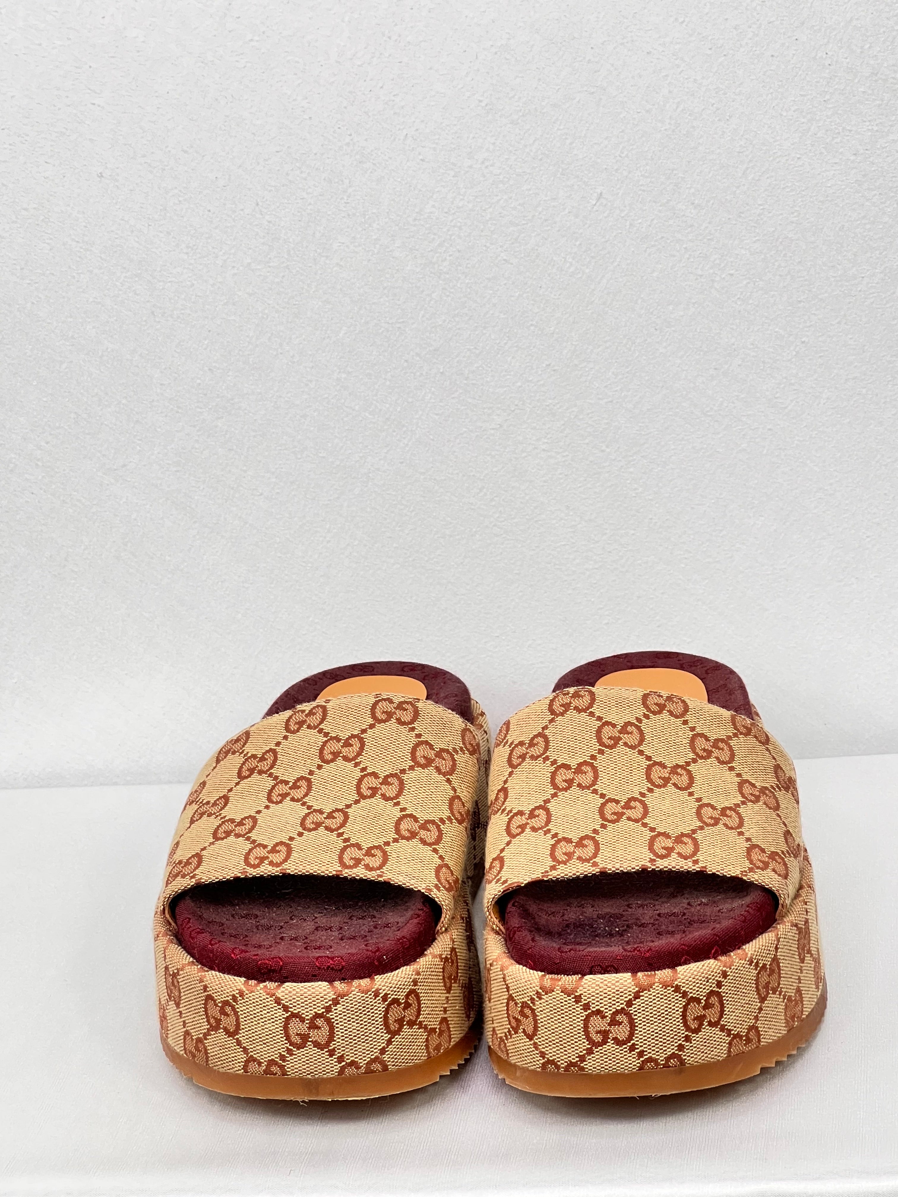 Front view of pre-owned women’s Gucci GG platform sliders in beige and brown monogram canvas.